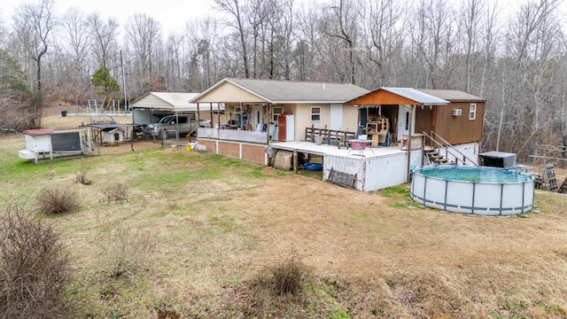 rear view of property featuring a yard