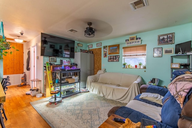 living room featuring hardwood / wood-style floors and ceiling fan