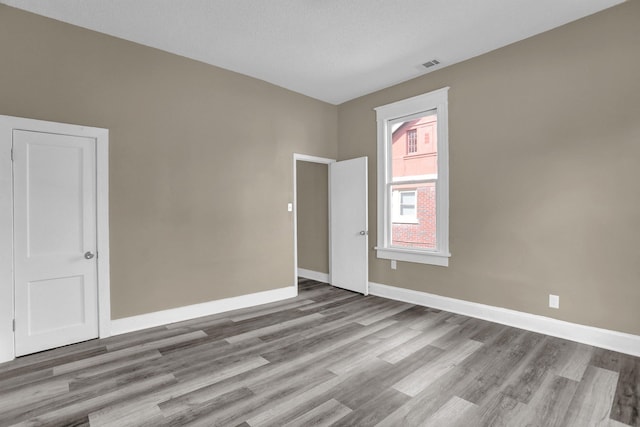 spare room with light hardwood / wood-style flooring