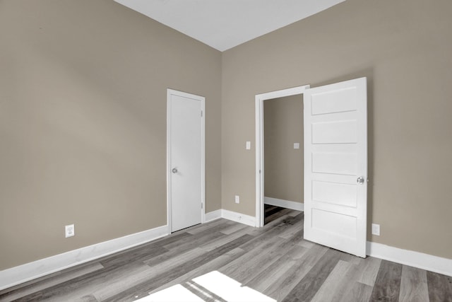 unfurnished bedroom with light wood-type flooring