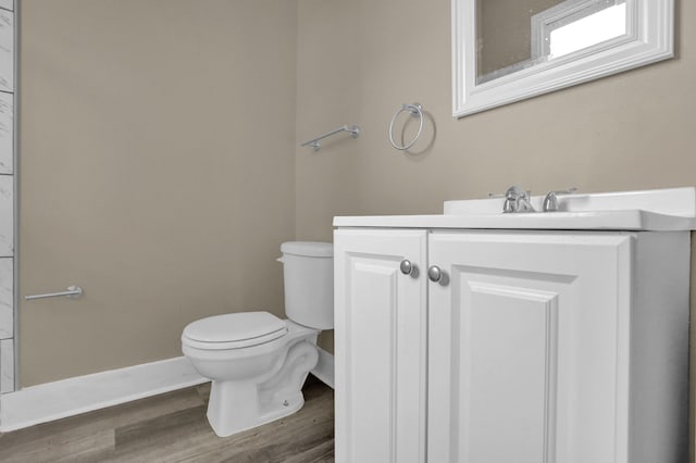 bathroom featuring vanity, toilet, and wood-type flooring