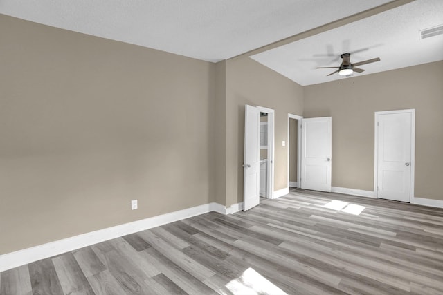 unfurnished bedroom with ceiling fan, a textured ceiling, and light hardwood / wood-style floors