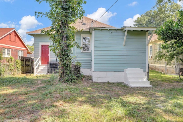 back of property with a yard