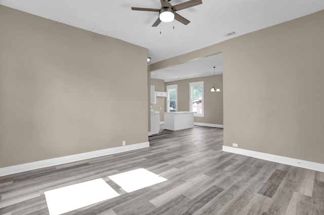 unfurnished living room featuring ceiling fan and light wood-type flooring