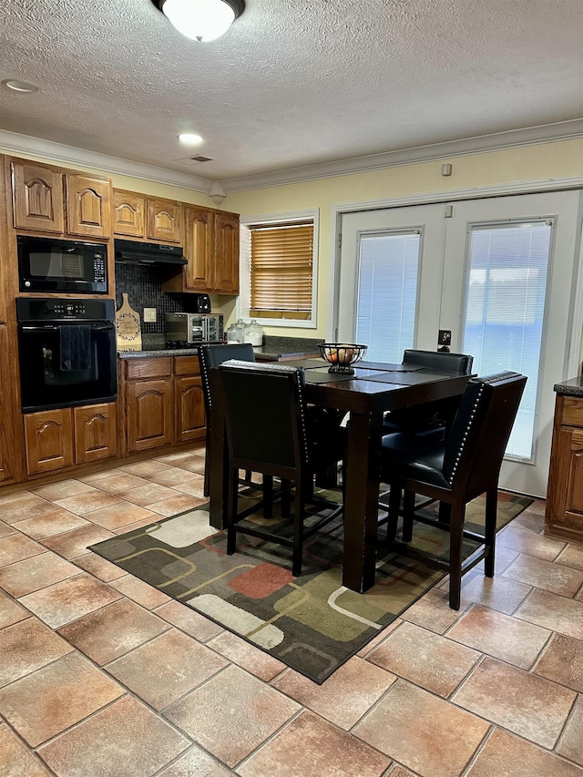 dining area with crown molding and a textured ceiling