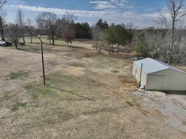 view of yard with an outdoor structure and a rural view