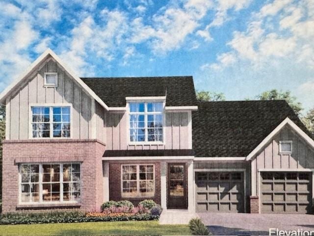 view of front of property with a garage, brick siding, and board and batten siding