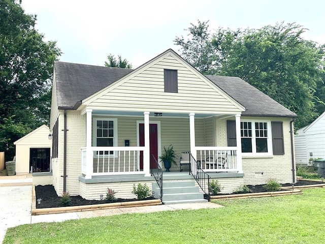 bungalow-style house with a front yard and a porch