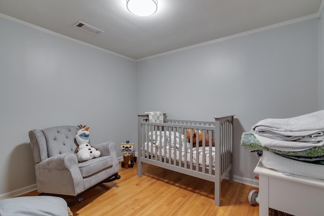 bedroom featuring hardwood / wood-style flooring and ornamental molding