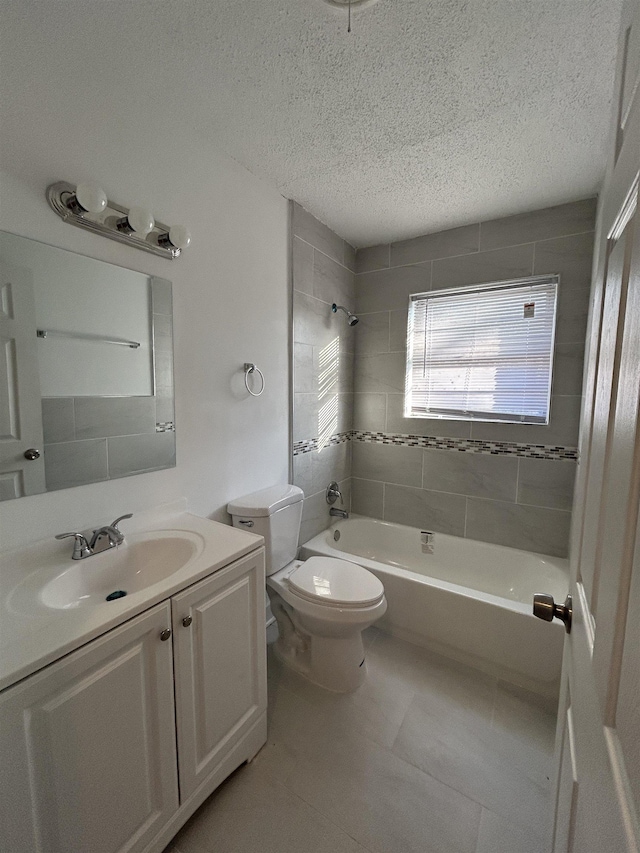 full bathroom with toilet, a textured ceiling, vanity, tiled shower / bath combo, and tile patterned flooring