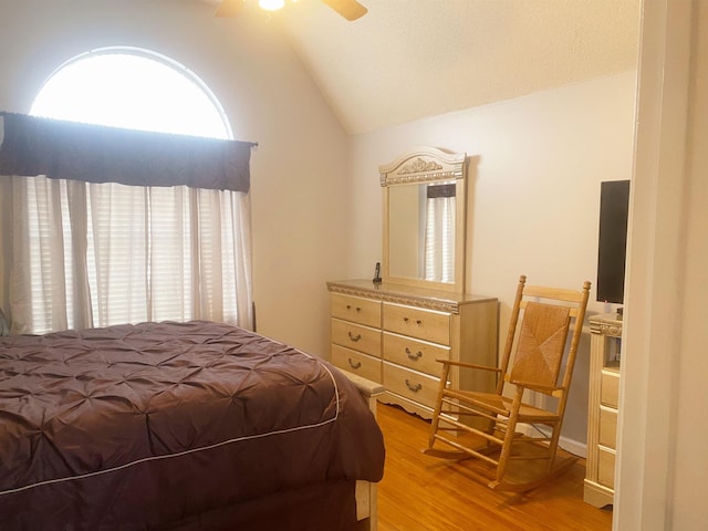 bedroom with vaulted ceiling, ceiling fan, and light hardwood / wood-style floors