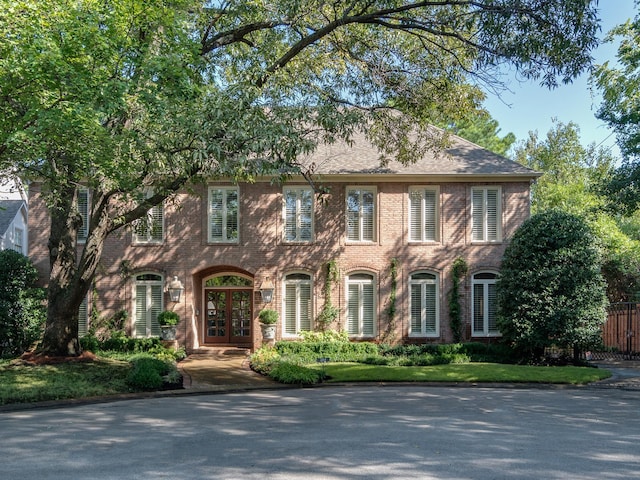 colonial house featuring french doors