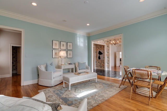 living room with crown molding, hardwood / wood-style floors, and a notable chandelier