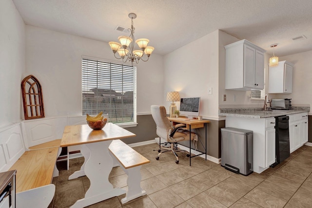 kitchen featuring pendant lighting, sink, and white cabinetry