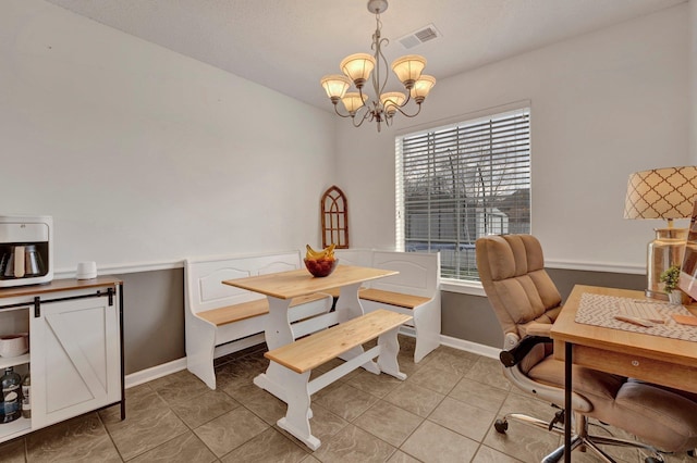 dining room with an inviting chandelier and light tile patterned floors