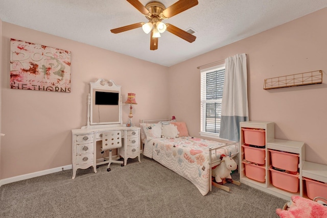 bedroom featuring ceiling fan, carpet floors, and a textured ceiling