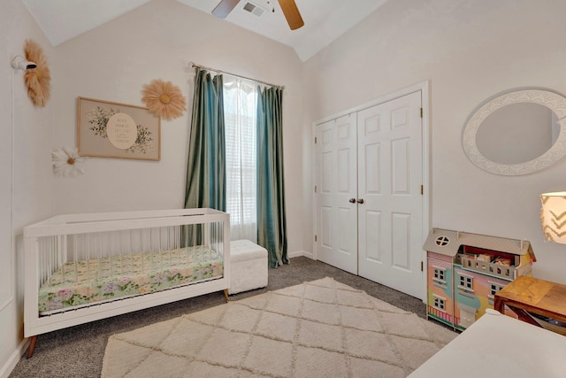 carpeted bedroom featuring vaulted ceiling, a closet, and ceiling fan