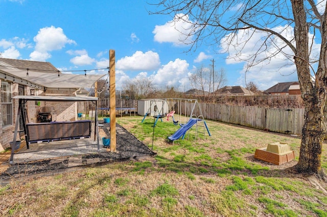 view of yard with a trampoline, an outdoor hangout area, and a playground