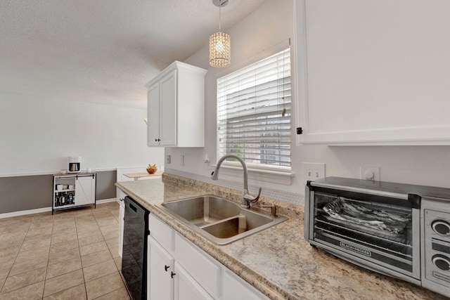 kitchen featuring light tile patterned flooring, sink, hanging light fixtures, black dishwasher, and white cabinets