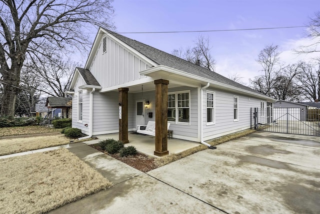 view of side of home with a porch and a garage