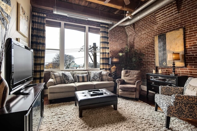 living room featuring brick wall