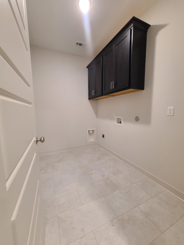 laundry area featuring light tile patterned flooring, gas dryer hookup, cabinets, hookup for a washing machine, and electric dryer hookup