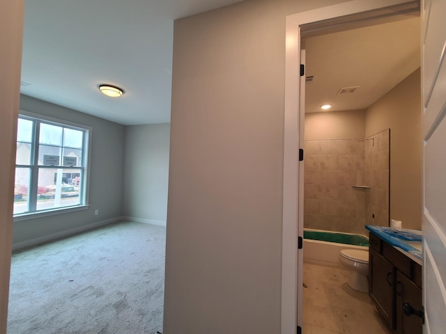 full bathroom with vanity, toilet, and tiled shower / bath combo