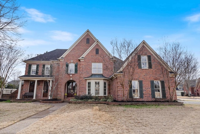 view of front of home with a front yard and covered porch