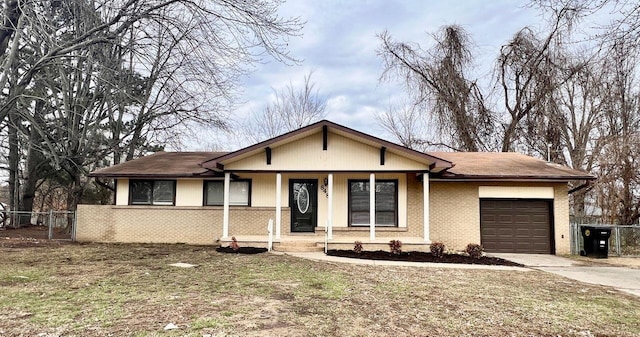 view of front of home with a garage and a front lawn