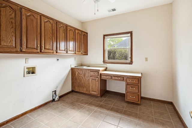 washroom featuring ceiling fan, light tile patterned floors, hookup for a washing machine, hookup for an electric dryer, and cabinet space