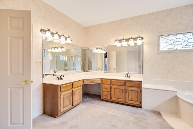 bathroom with a sink, double vanity, and a garden tub
