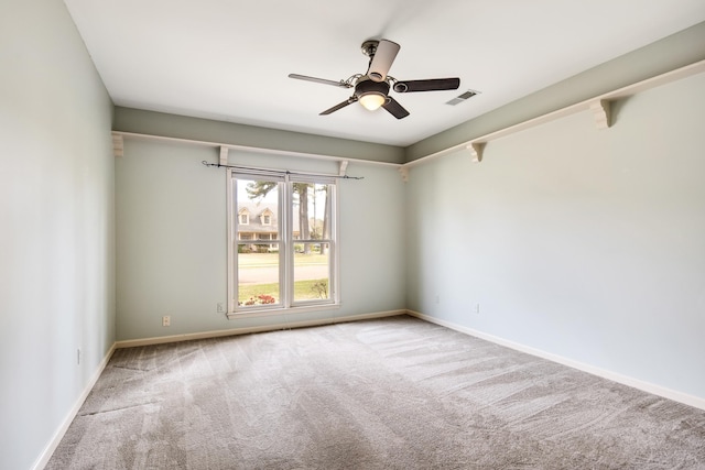 carpeted empty room featuring ceiling fan, baseboards, and visible vents