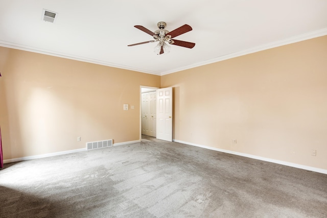carpeted spare room featuring crown molding, visible vents, ceiling fan, and baseboards