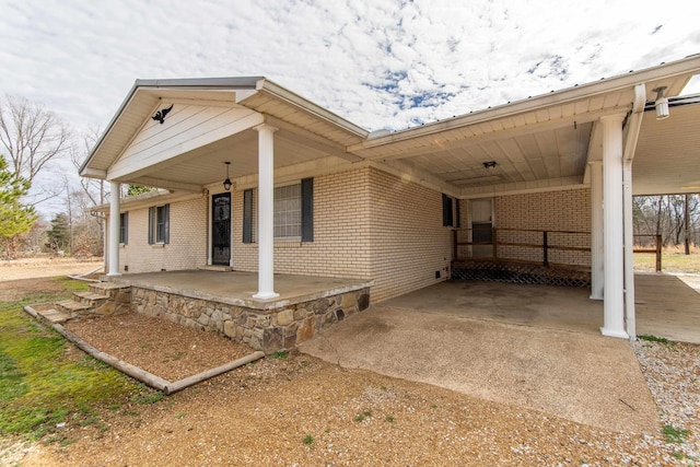 exterior space featuring a carport and a porch