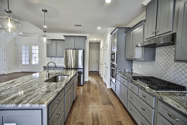 kitchen featuring gray cabinets, decorative light fixtures, sink, dark stone countertops, and stainless steel appliances