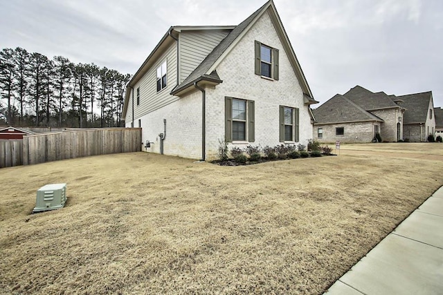 view of side of home featuring a yard