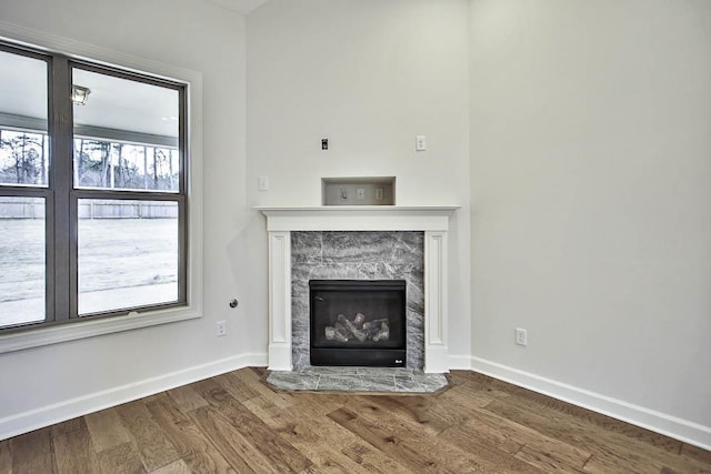 unfurnished living room with hardwood / wood-style flooring and a fireplace