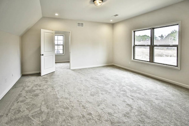 bonus room with lofted ceiling and carpet