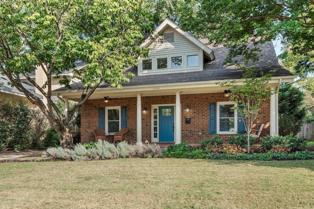 view of front of home featuring covered porch and a front lawn