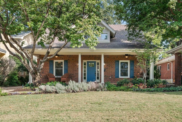 view of front of home featuring a front yard and covered porch