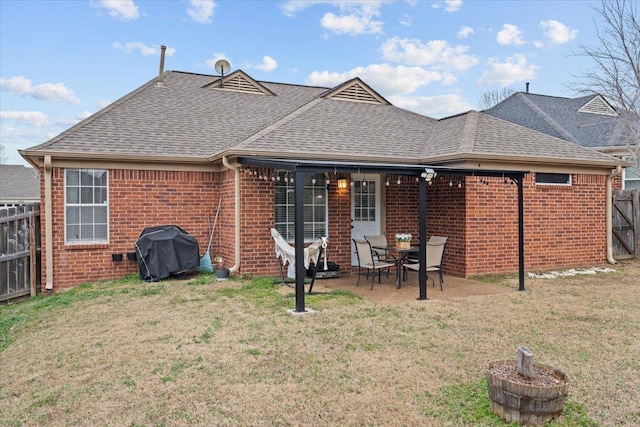 rear view of house featuring a yard and a patio area