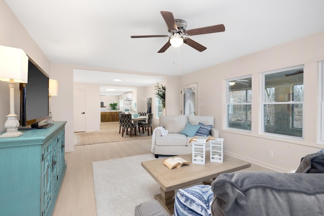 living room featuring ceiling fan and light wood-type flooring