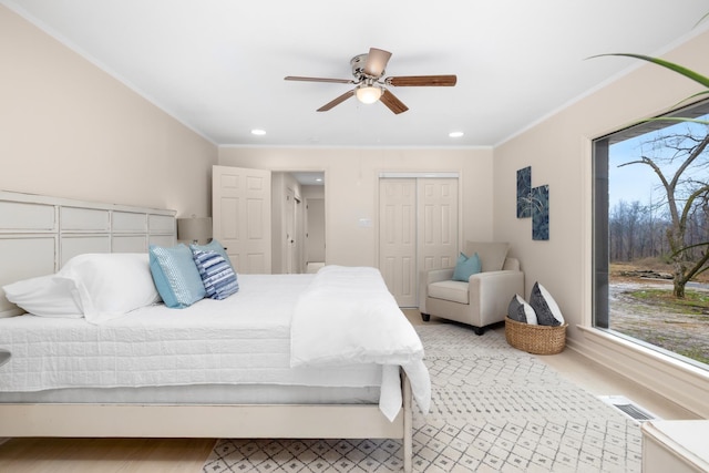 bedroom with multiple windows, ornamental molding, a closet, and ceiling fan