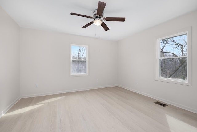 spare room with ceiling fan and light hardwood / wood-style floors