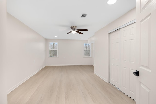 unfurnished room with ceiling fan and light wood-type flooring