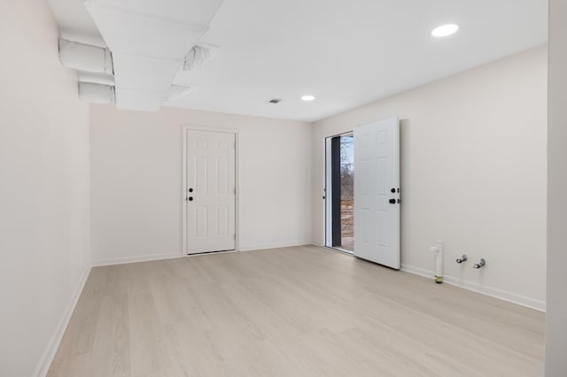 unfurnished room with light hardwood / wood-style floors