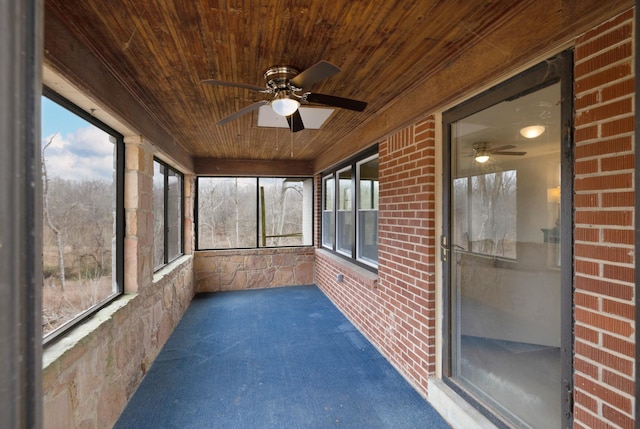 unfurnished sunroom with wooden ceiling