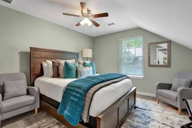 bedroom with dark colored carpet, lofted ceiling, and ceiling fan