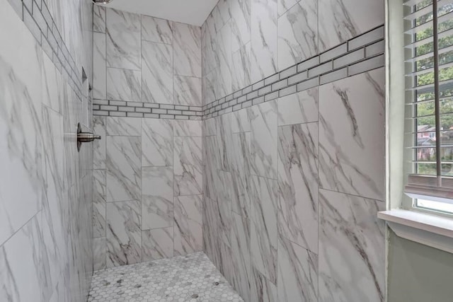 bathroom with a tile shower