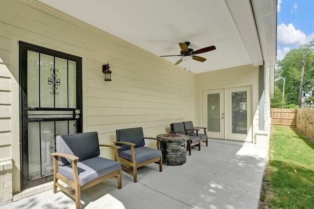 view of patio featuring ceiling fan and a fire pit